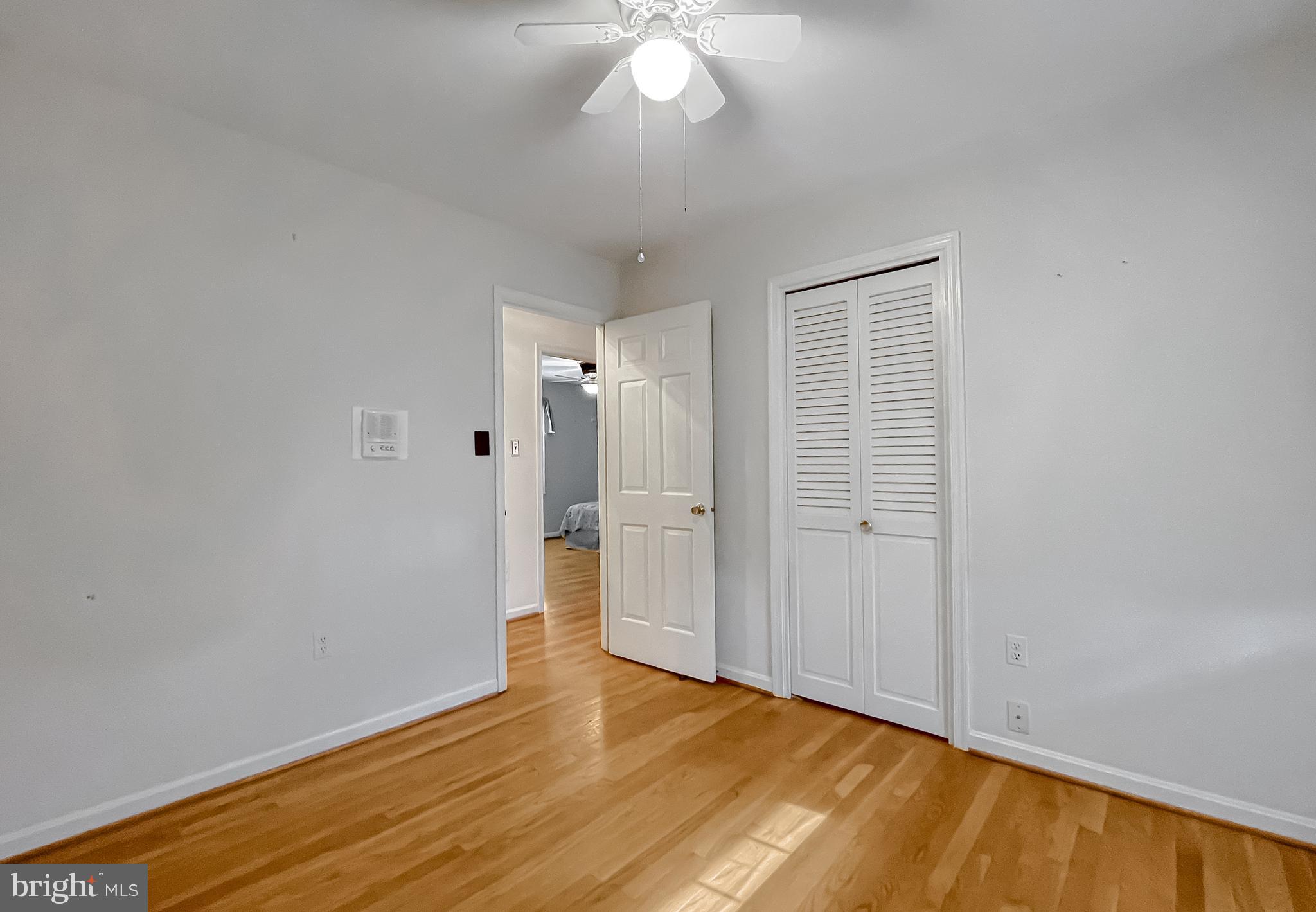 7004 Vismanco Lane Clinton, MD 20735 - Photo 39 of 63 a view of an empty room with wooden floor and a window