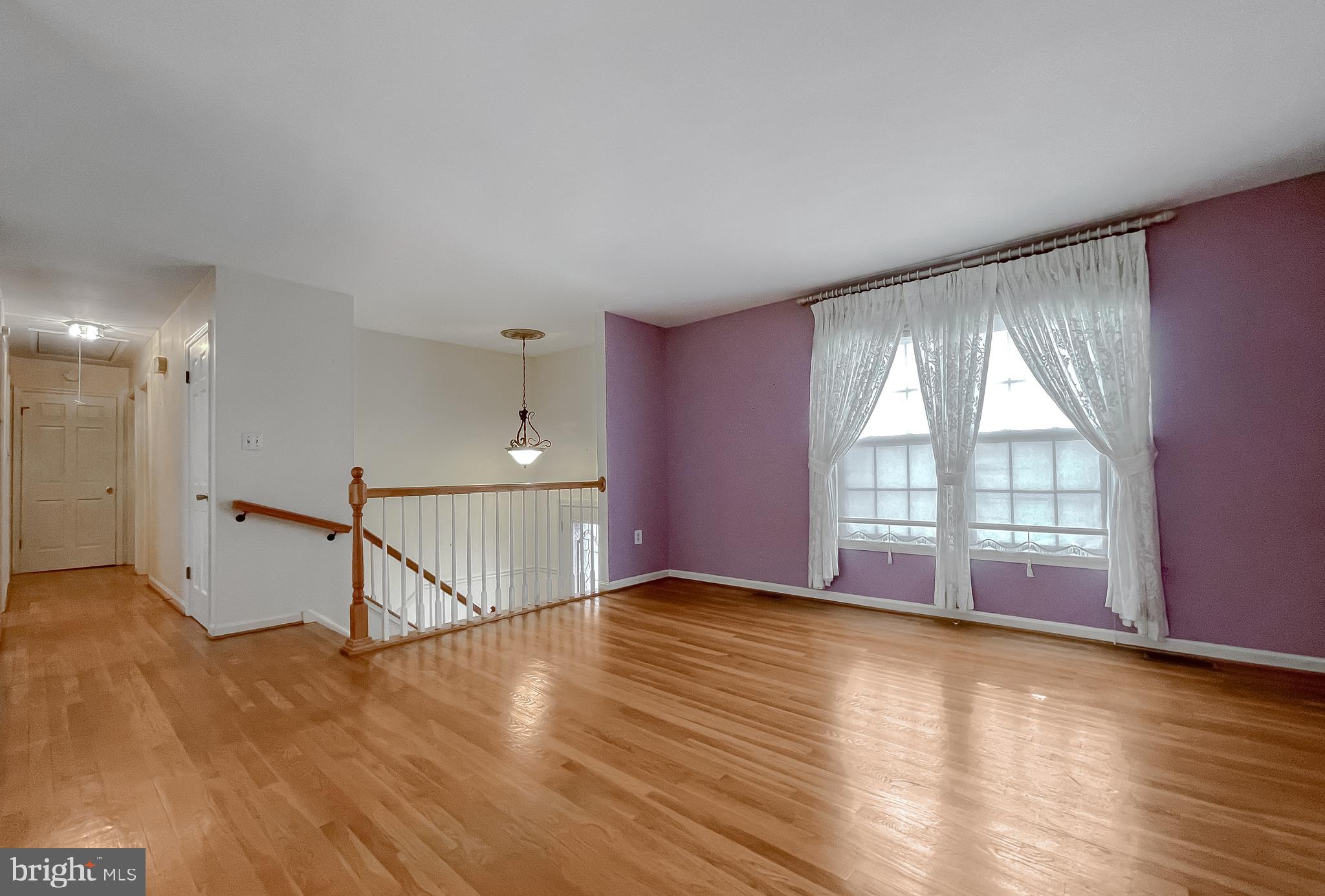 7004 Vismanco Lane Clinton, MD 20735 - Photo 5 of 63 a view of an empty room with wooden floor and a window