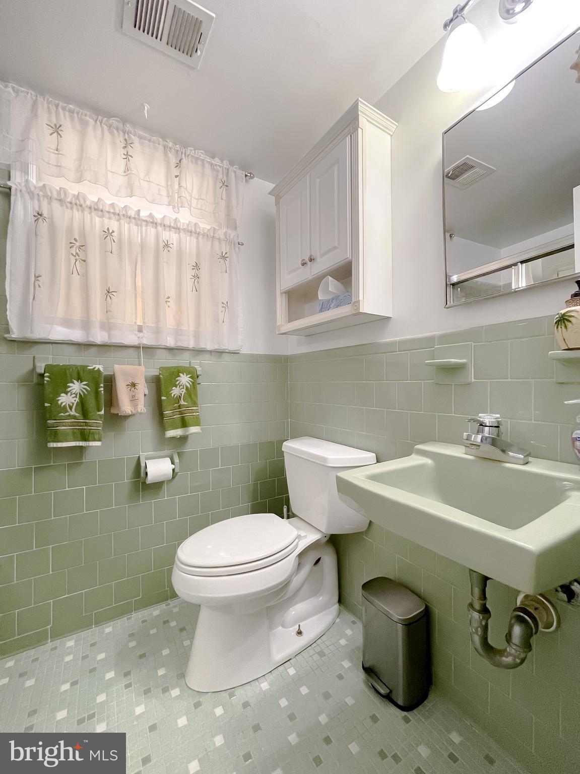 7004 Vismanco Lane Clinton, MD 20735 - Photo 52 of 63 a bathroom with a sink a toilet and a mirror