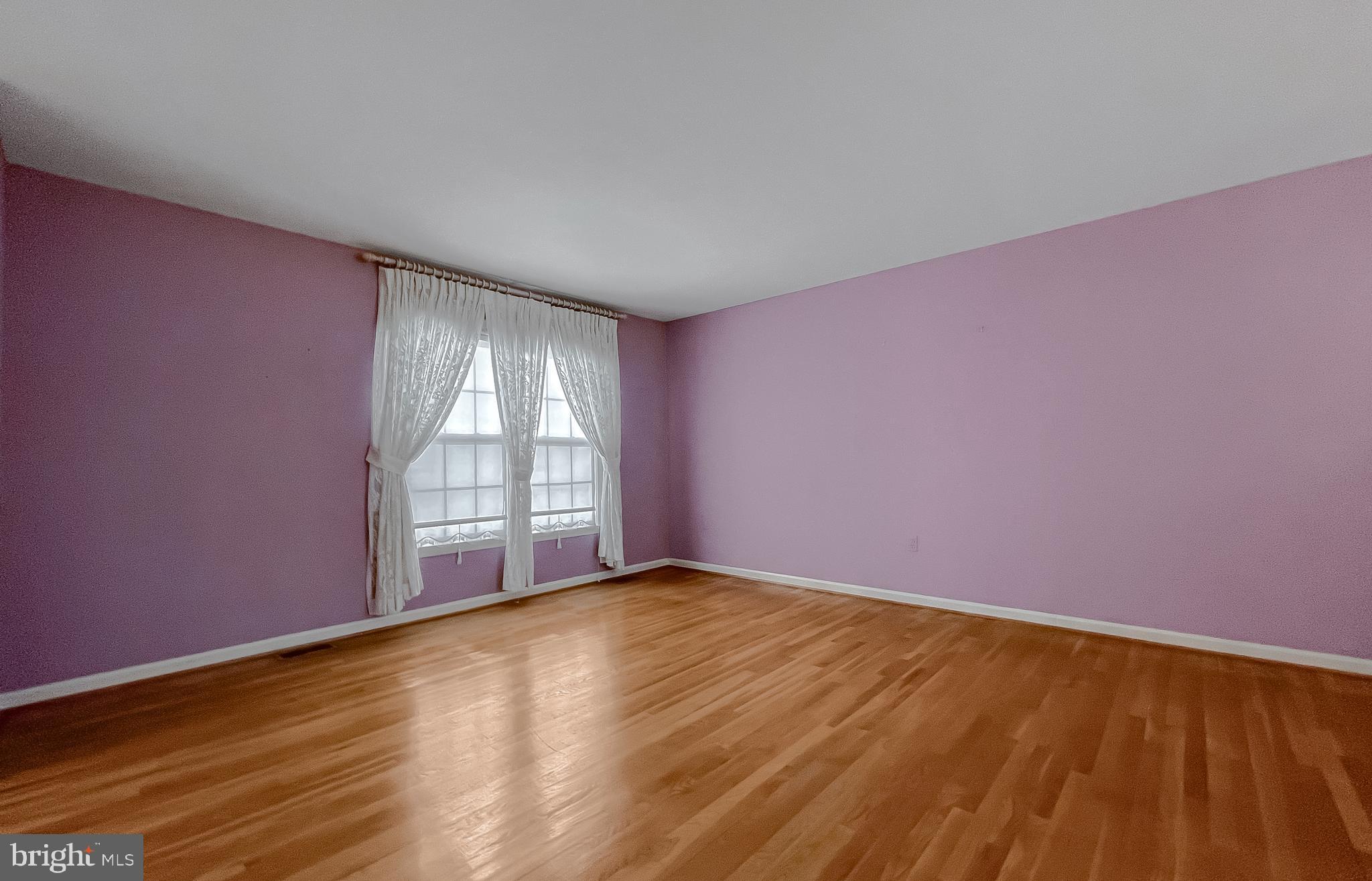 7004 Vismanco Lane Clinton, MD 20735 - Photo 7 of 63 a view of an empty room with wooden floor and a window
