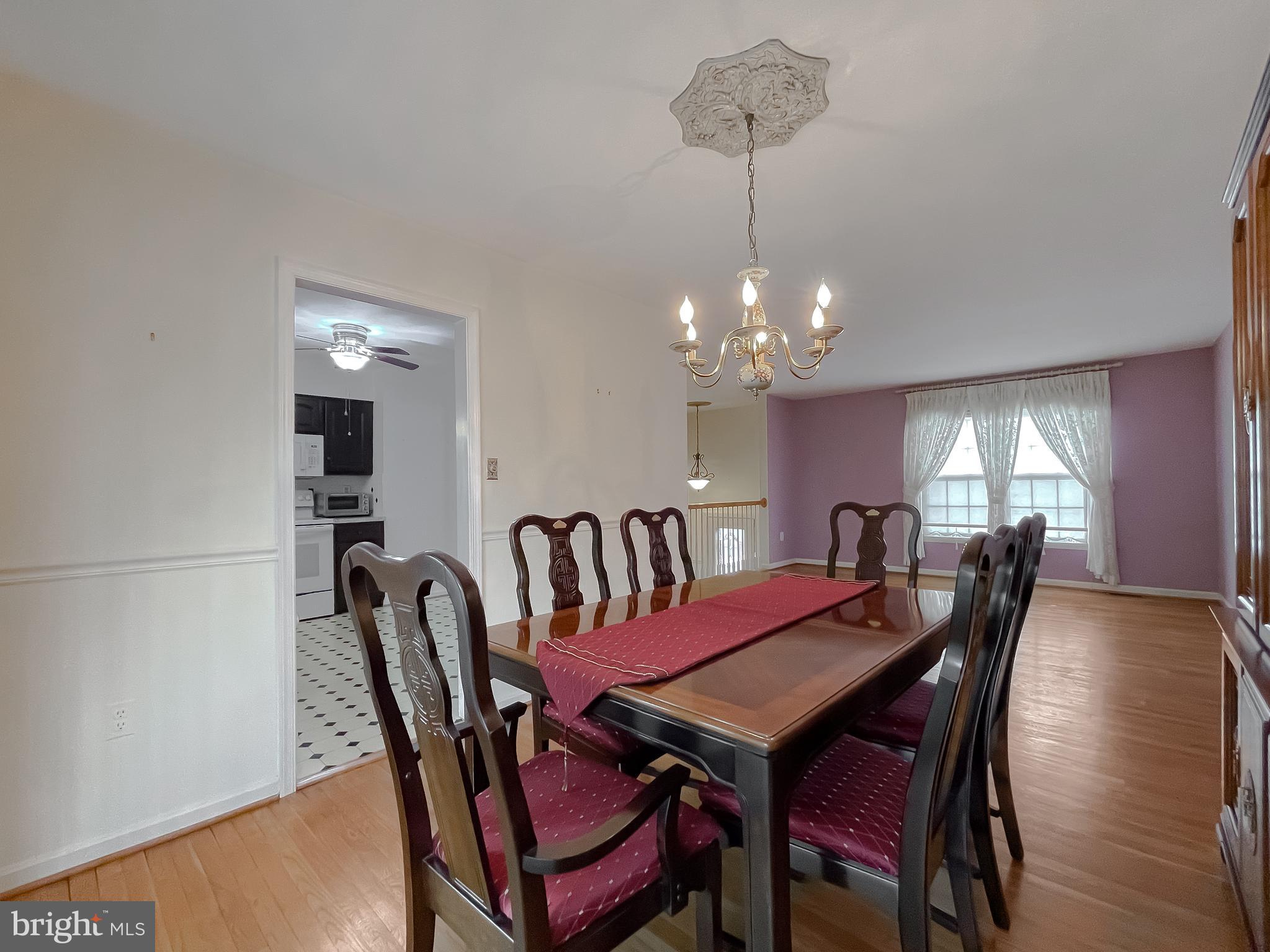 7004 Vismanco Lane Clinton, MD 20735 - Photo 10 of 63 a view of a dining room with furniture and wooden floor
