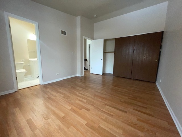 1267 Maroon Drive Elgin, IL 60120 - Photo 13 of 23 a view of an empty room with wooden floor and door