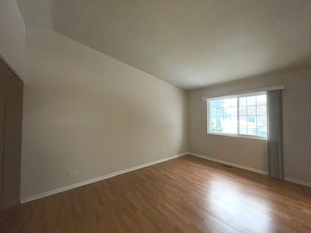 1267 Maroon Drive Elgin, IL 60120 - Photo 15 of 23 an empty room with wooden floor and windows