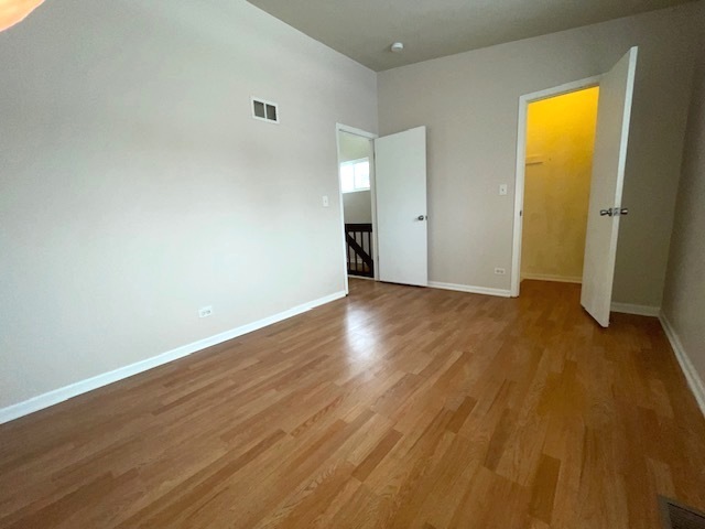 1267 Maroon Drive Elgin, IL 60120 - Photo 19 of 23 an empty room with wooden floor and windows