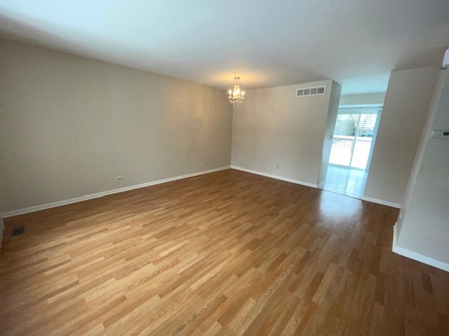 1267 Maroon Drive Elgin, IL 60120 - Photo 4 of 23 an empty room with wooden floor and windows