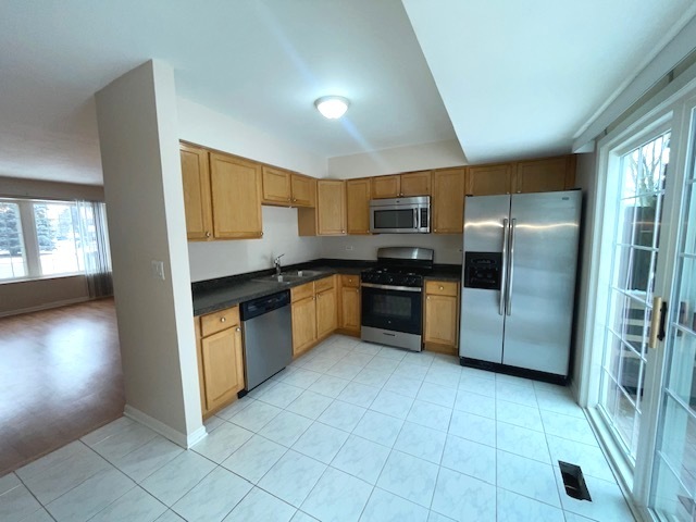 1267 Maroon Drive Elgin, IL 60120 - Photo 5 of 23 a kitchen with stainless steel appliances granite countertop a stove a sink and a refrigerator