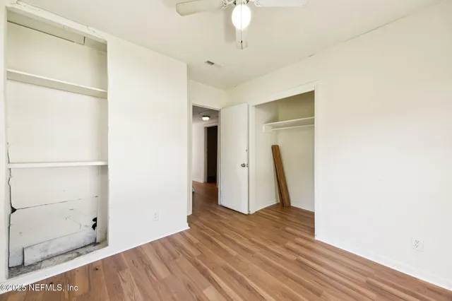 a view of empty room with wooden floor