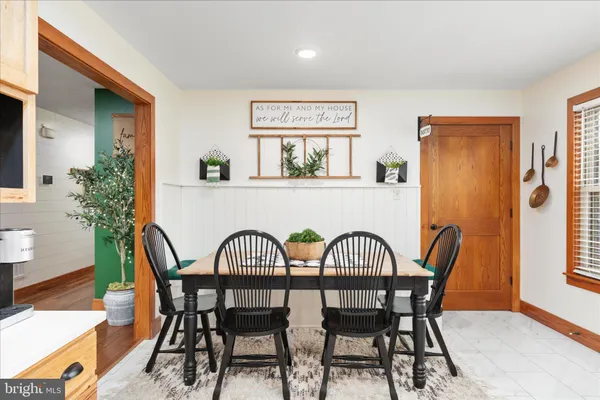 a utility room with lots of clutter and cabinets