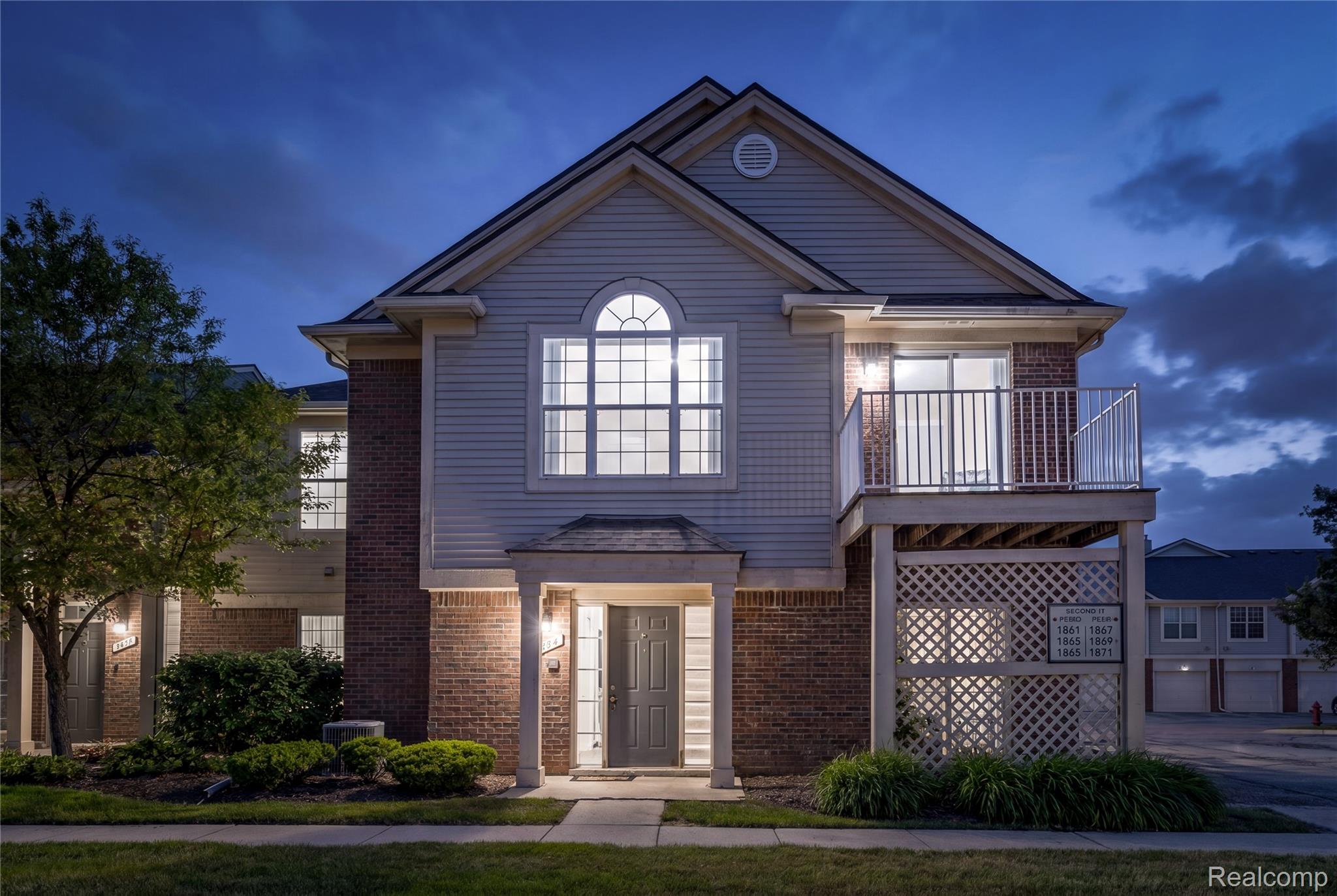 1861 Flagstone Circle Rochester, MI 48307 - Photo 20 of 21 Two-story building exterior featuring light-colored siding and brick accents
