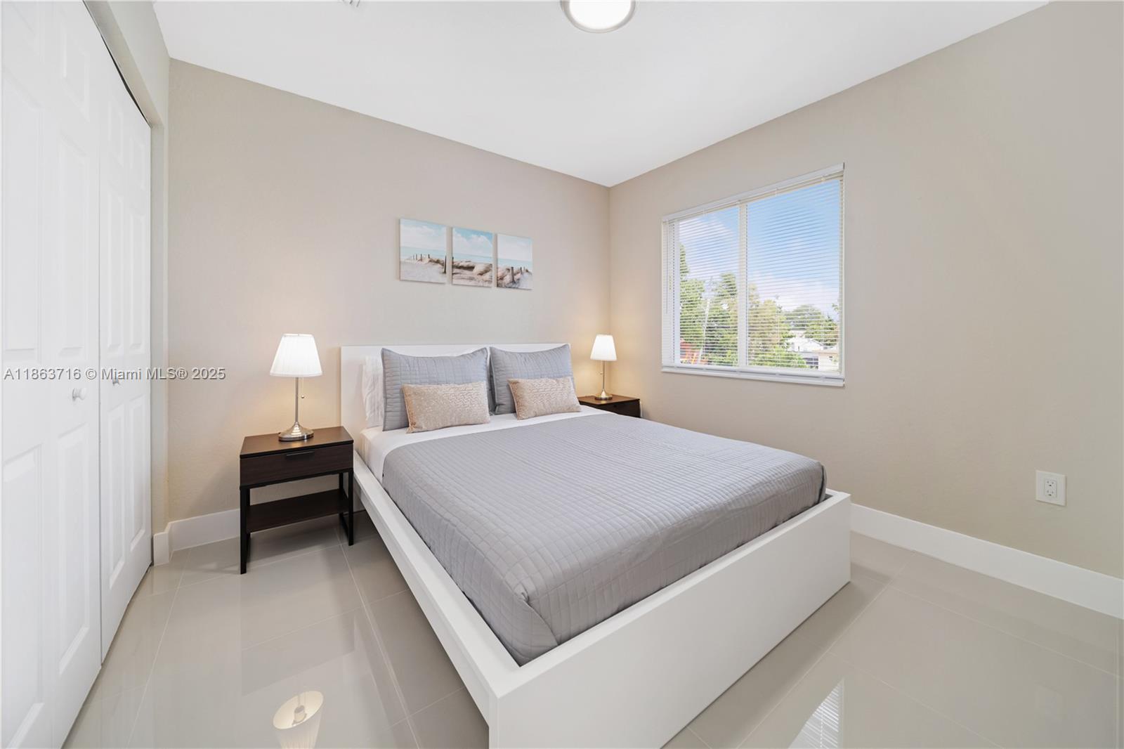 1183 Northeast 111th Street, Unit 1183 Miami, FL 33161 - Photo 12 of 20 a bedroom with a bed and a window