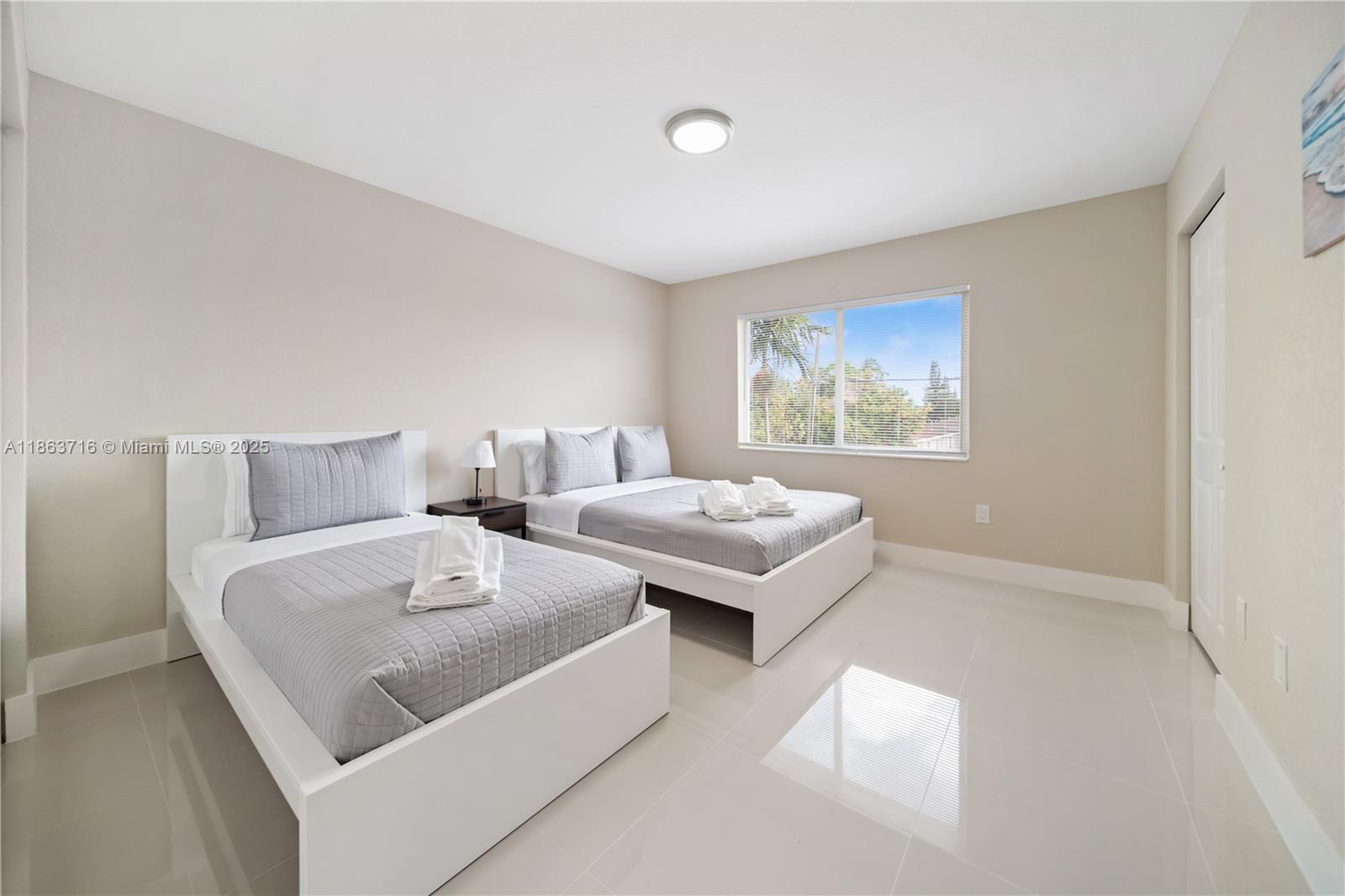 1183 Northeast 111th Street, Unit 1183 Miami, FL 33161 - Photo 13 of 20 a living room with furniture and a table