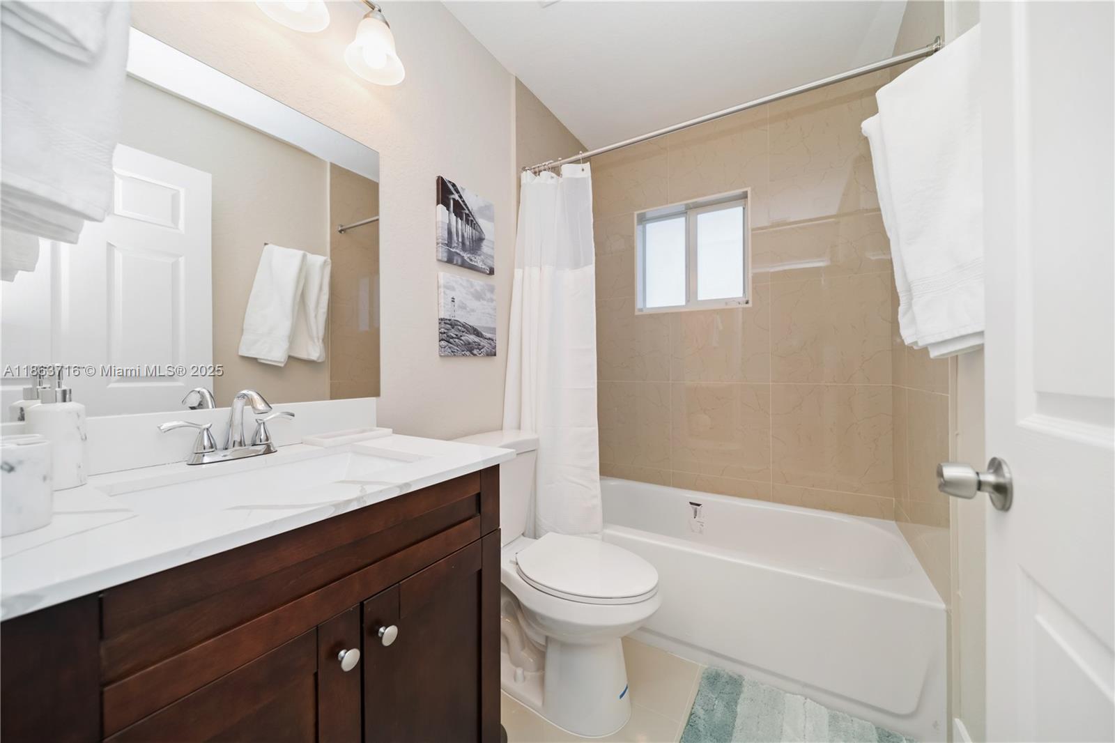 1183 Northeast 111th Street, Unit 1183 Miami, FL 33161 - Photo 15 of 20 a bathroom with a sink a toilet and shower