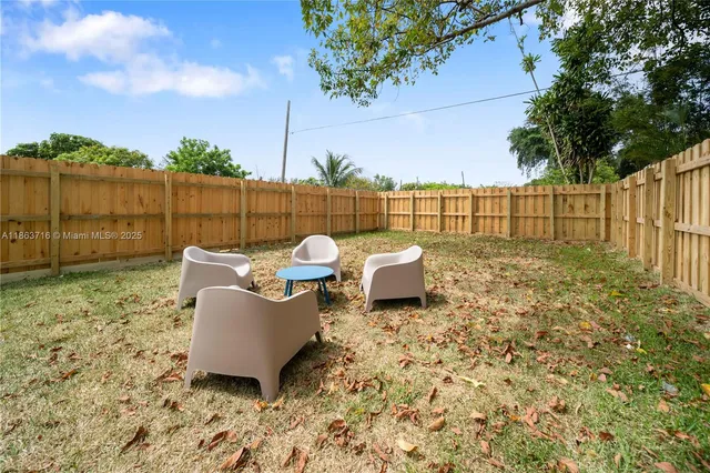a view of a backyard with sitting area