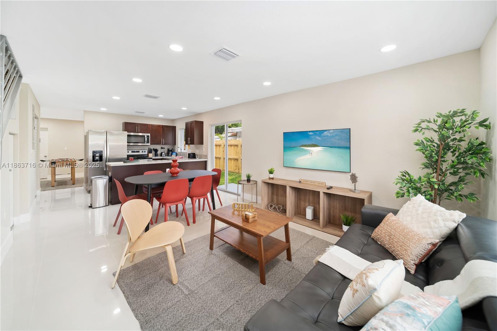 1183 Northeast 111th Street, Unit 1183 Miami, FL 33161 - Photo 4 of 20 a living room with furniture and a flat screen tv