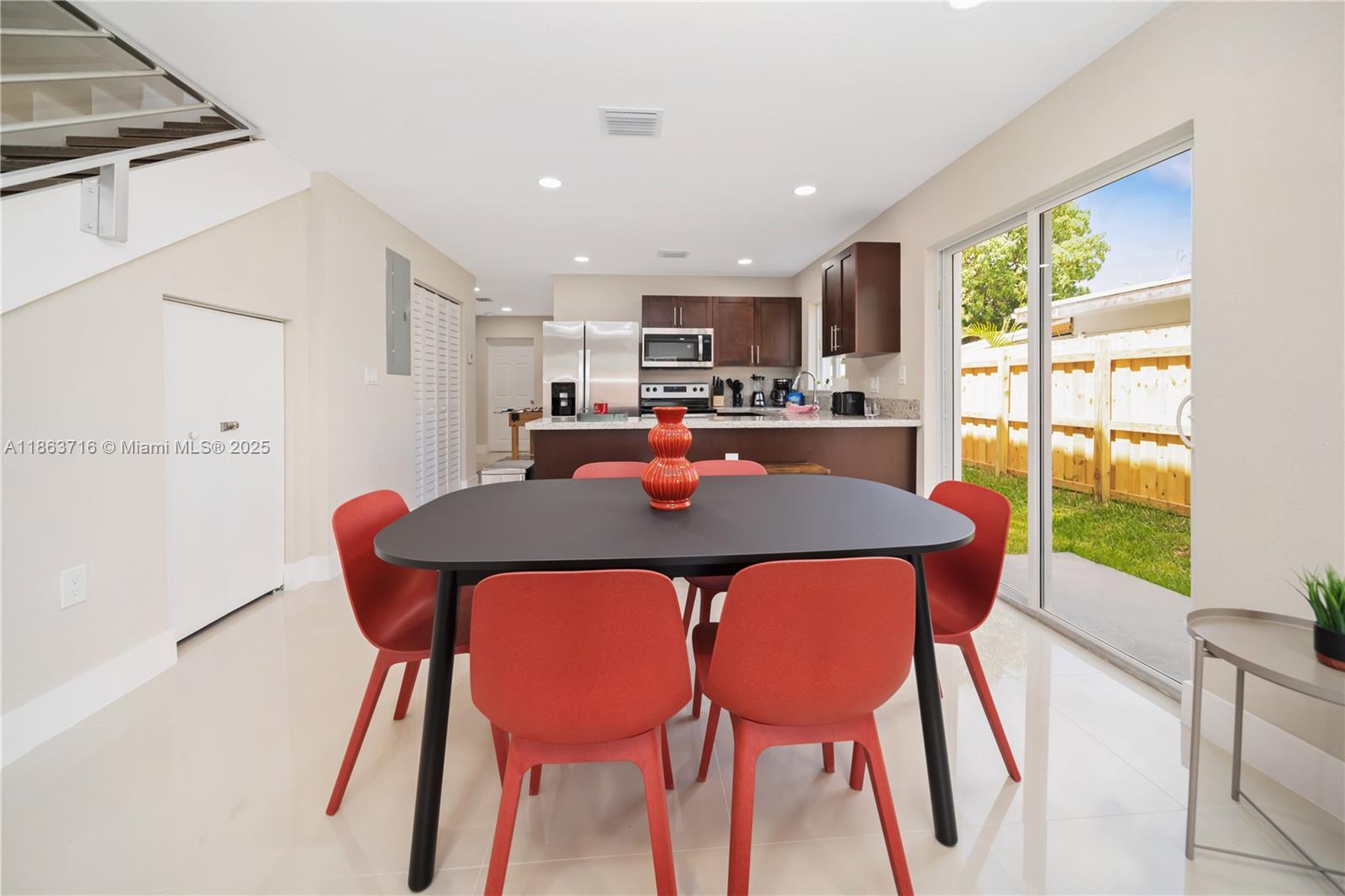 1183 Northeast 111th Street, Unit 1183 Miami, FL 33161 - Photo 5 of 20 a dining room with furniture and a floor to ceiling window