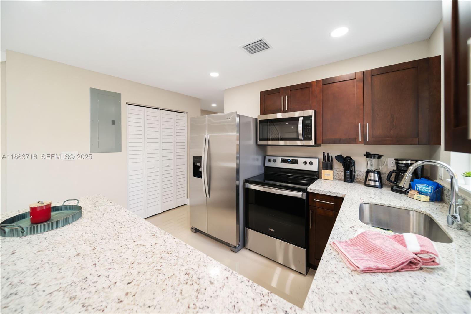 1183 Northeast 111th Street, Unit 1183 Miami, FL 33161 - Photo 7 of 20 a kitchen with a sink stove and refrigerator