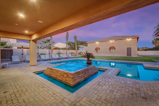 a dining room with furniture and a floor to ceiling window
