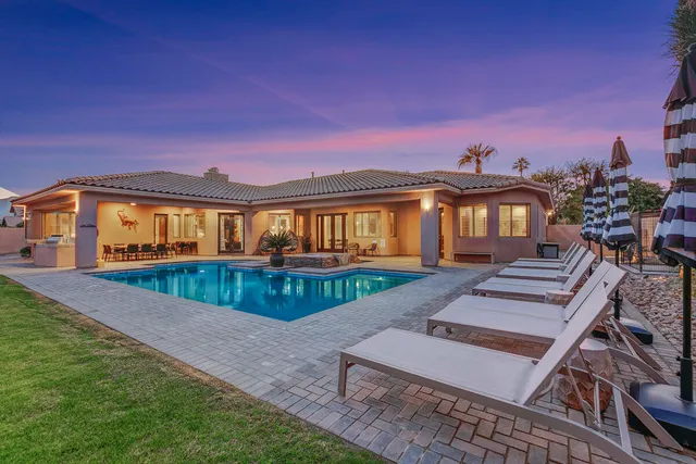 a view of a backyard with sitting area