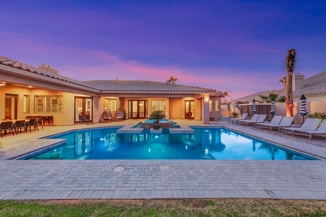 a kitchen with stainless steel appliances granite countertop a refrigerator a oven and a sink