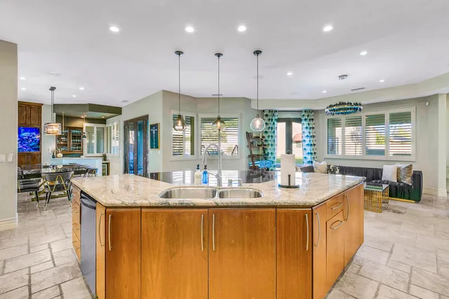 a spacious bathroom with a granite countertop sink and a mirror