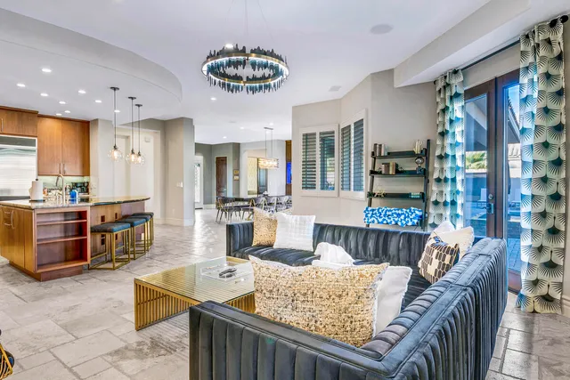 a bedroom with a bed and dresser with wooden floor