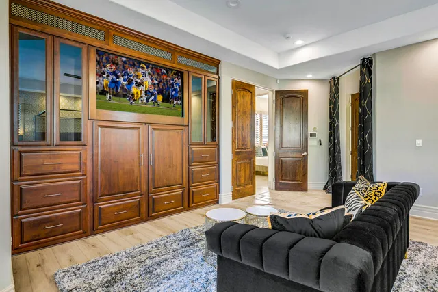 a living room with furniture kitchen view and a table