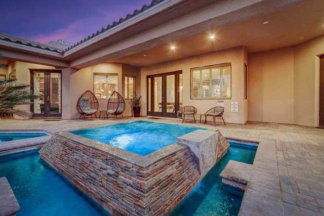 a living room with furniture pool table and a floor to ceiling window