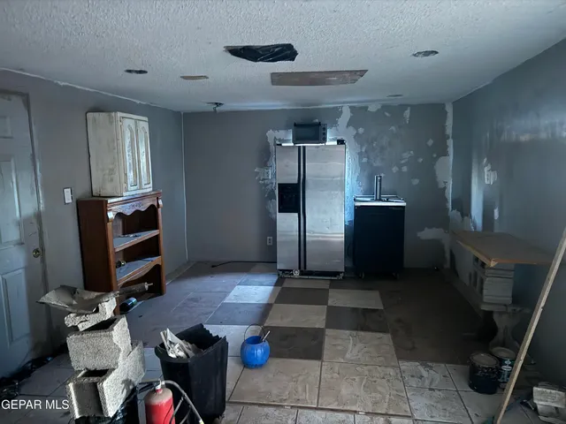 a kitchen with refrigerator and microwave