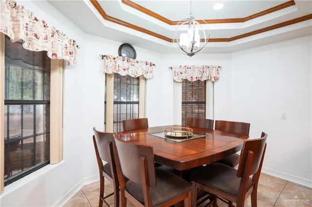 a dining room with furniture a chandelier and window