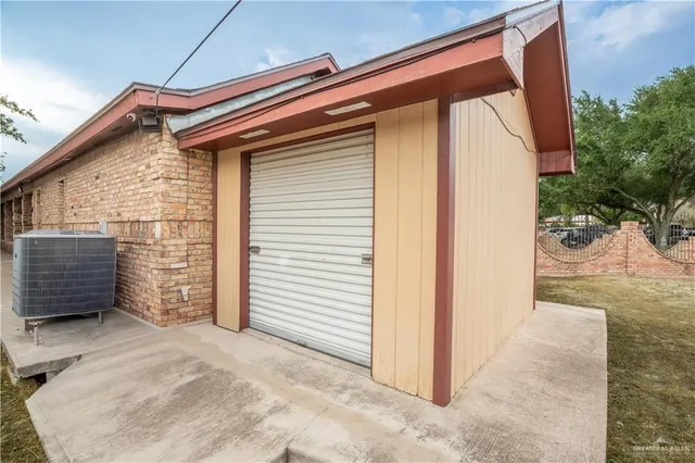 a front view of a house with a yard and tree s