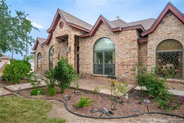an aerial view of a house with garden space and sitting area