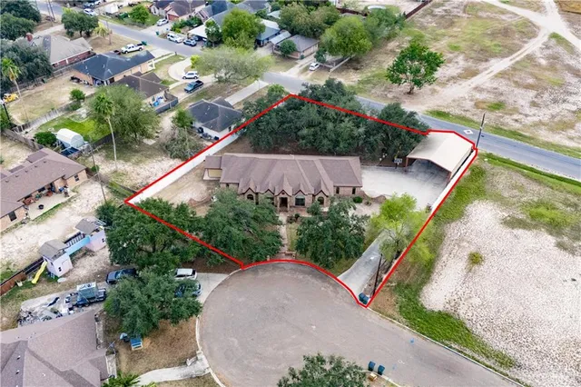 an aerial view of a house with a yard and garden