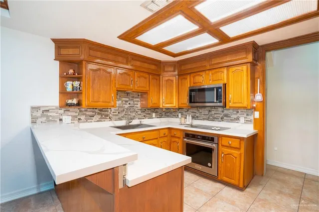 a kitchen with stainless steel appliances granite countertop a stove and a sink