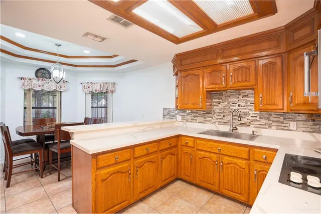 a kitchen with granite countertop a sink and cabinets