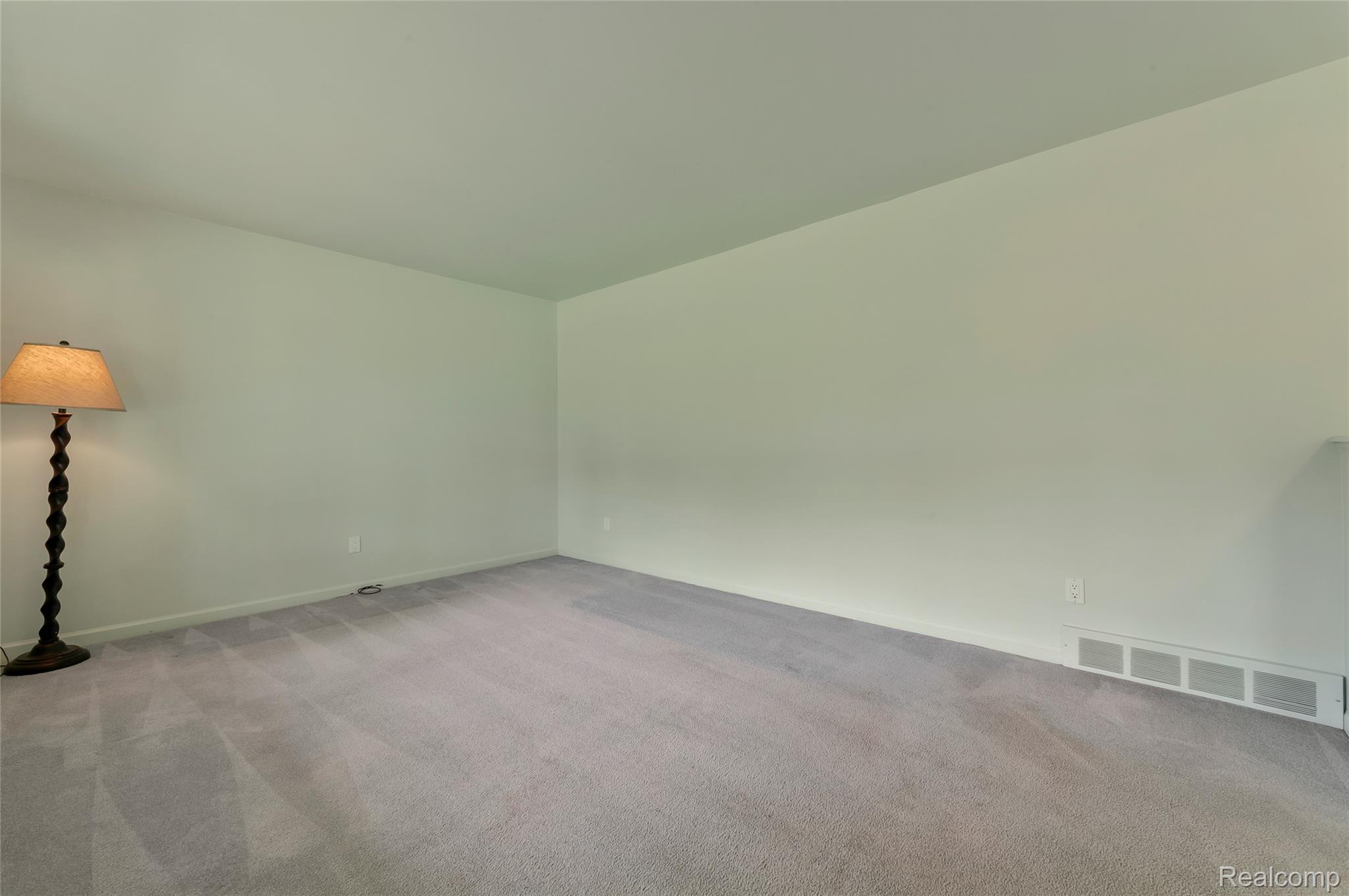 8887 Clark Road Clarkston, MI 48346 - Photo 9 of 40 Spare room featuring carpet flooring and baseboards