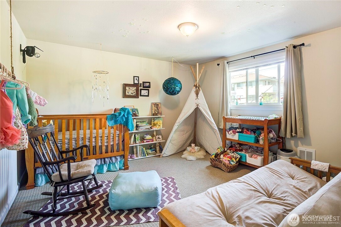 2357 Northwest 65th Street Seattle, WA 98117 - Photo 13 of 20 a bedroom with furniture and a window