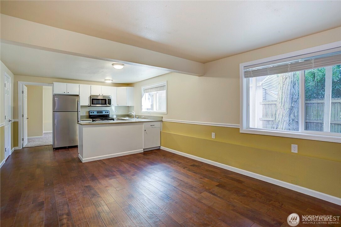 2357 Northwest 65th Street Seattle, WA 98117 - Photo 15 of 20 a large kitchen with stainless steel appliances granite countertop a stove and a refrigerator