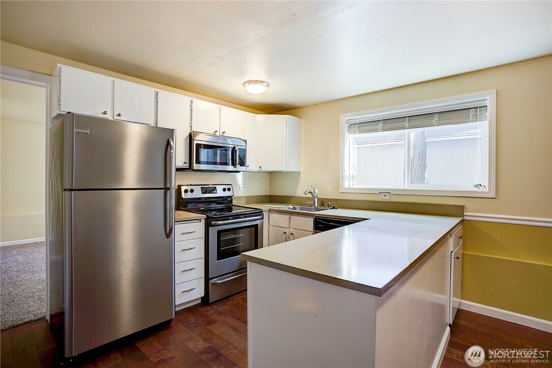 2357 Northwest 65th Street Seattle, WA 98117 - Photo 16 of 20 a kitchen with a refrigerator sink and stove