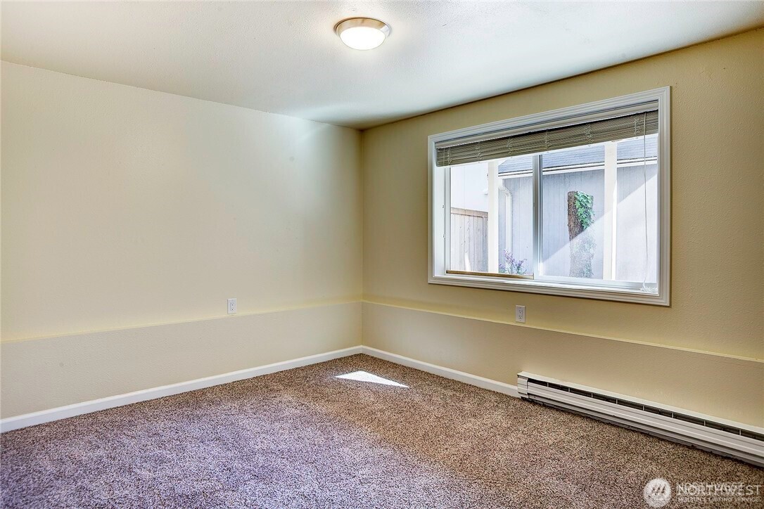 2357 Northwest 65th Street Seattle, WA 98117 - Photo 18 of 20 a view of a small space with wooden floor and a window