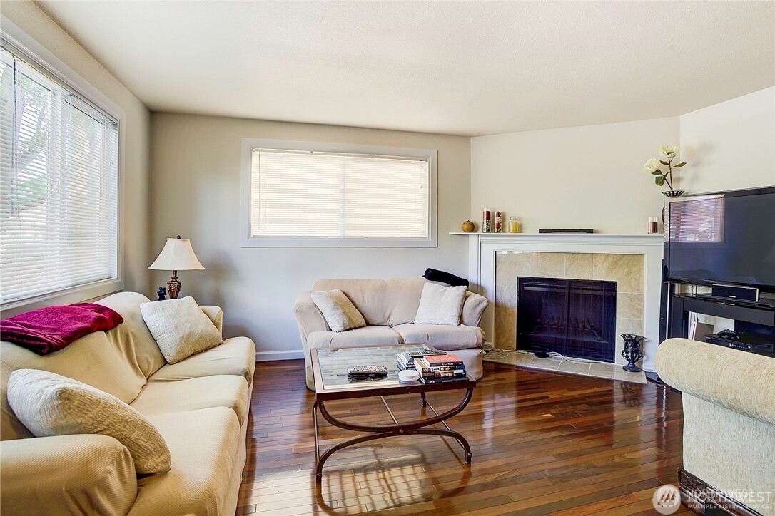 2357 Northwest 65th Street Seattle, WA 98117 - Photo 4 of 20 a living room with furniture a fireplace and a large window