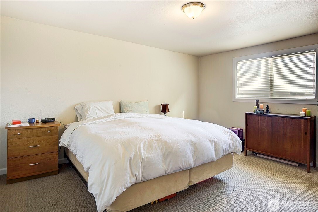2357 Northwest 65th Street Seattle, WA 98117 - Photo 7 of 20 a bedroom with a bed and a window