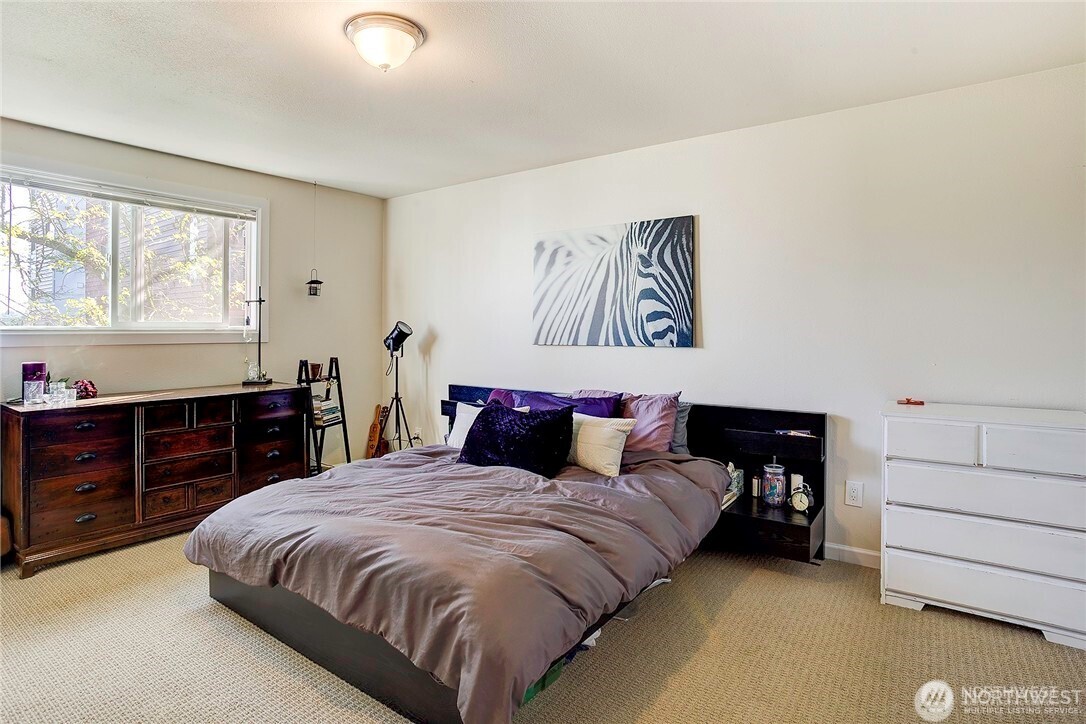 2357 Northwest 65th Street Seattle, WA 98117 - Photo 10 of 20 a bedroom with a bed and dresser