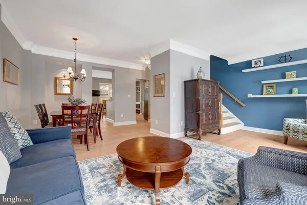 a living room with furniture and a chandelier