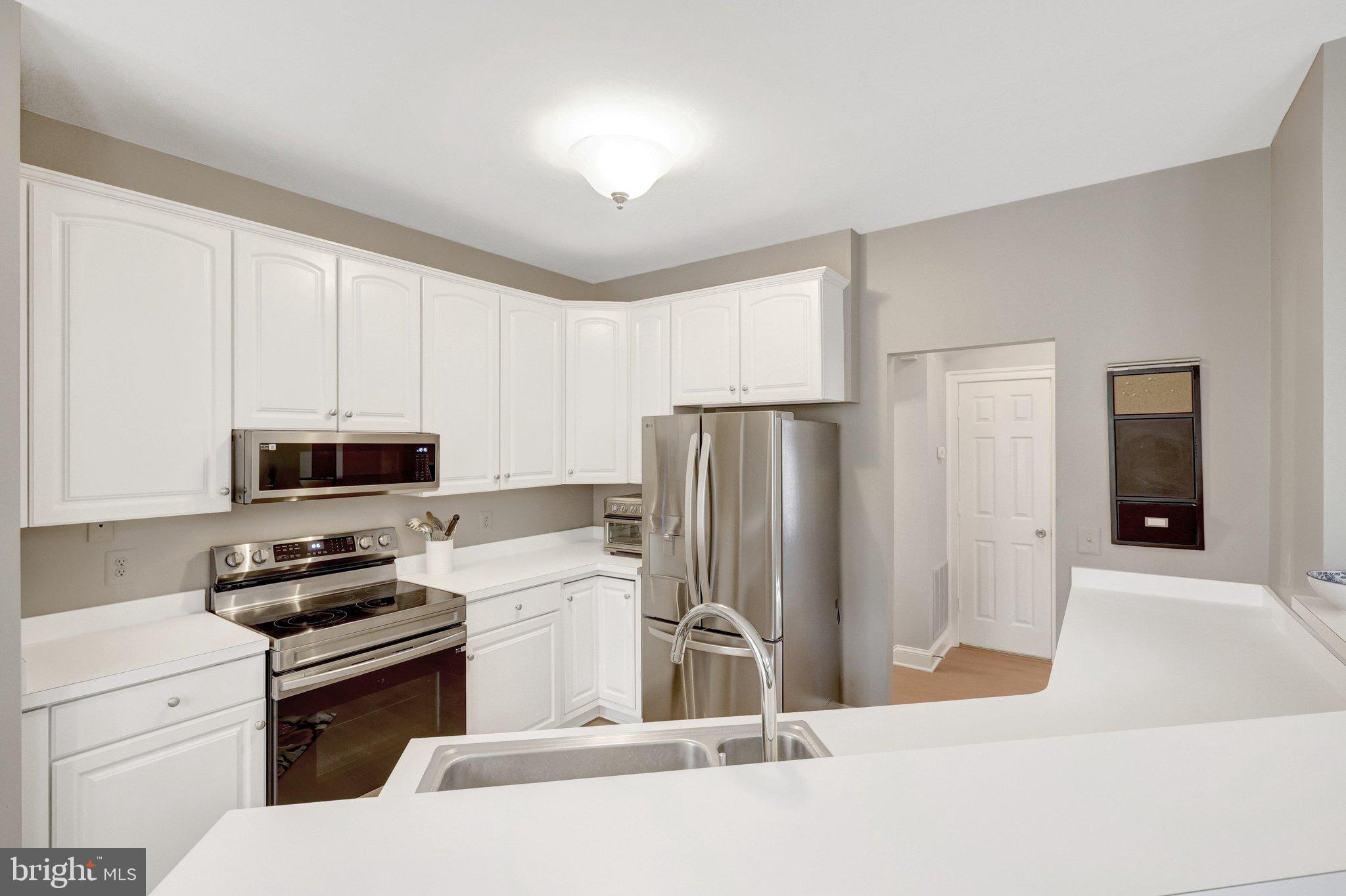 1309 Sundial Drive Reston, VA 20194 - Photo 4 of 45 a kitchen with stainless steel appliances a refrigerator stove and microwave