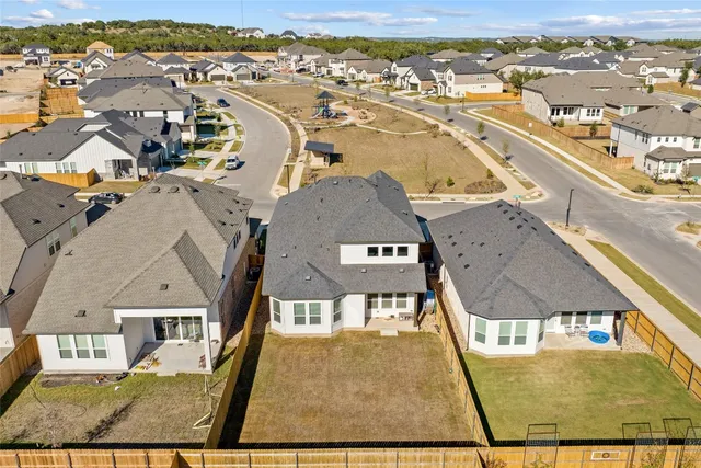 an aerial view of a swimming pool with outdoor seating