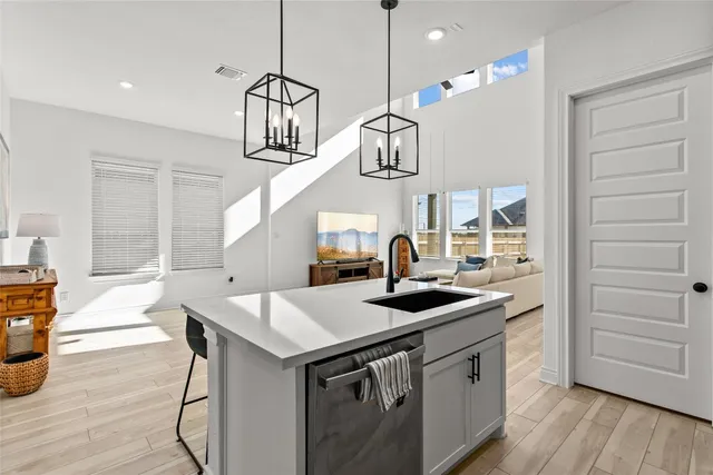 a kitchen with a sink a stove and cabinets