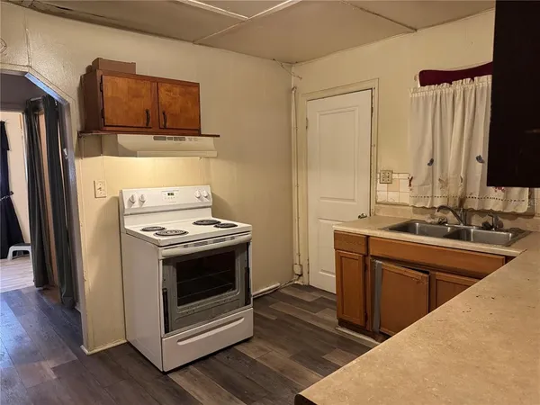 a kitchen with stainless steel appliances a stove a sink and a refrigerator