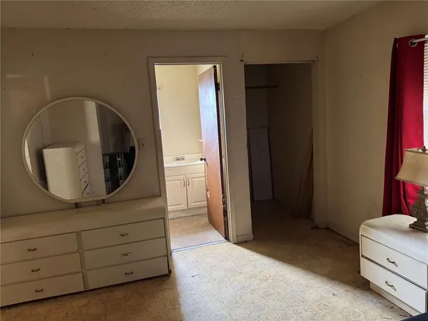 a view of a dresser and mirror in a room