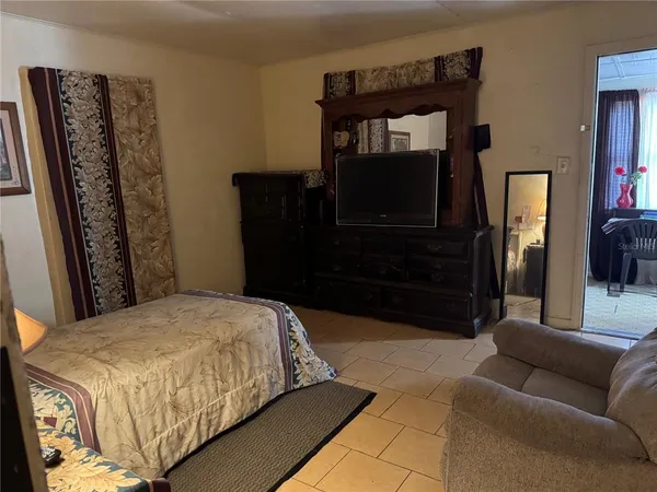 a bedroom with a bed a rug and dresser