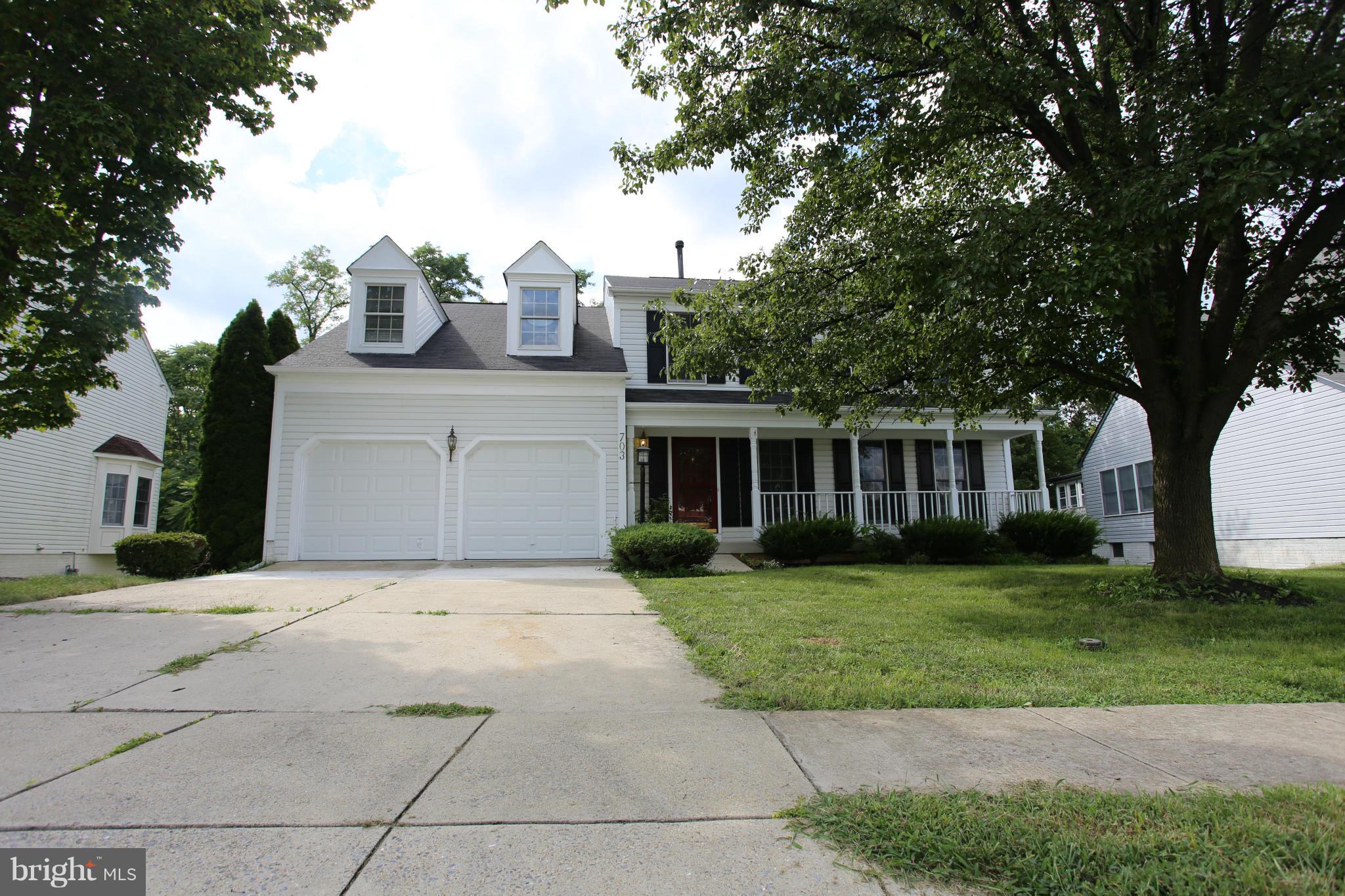 703 Monarch Ridge Road Frederick, MD 21703 - Photo 1 of 30 a front view of a house with a garden and trees